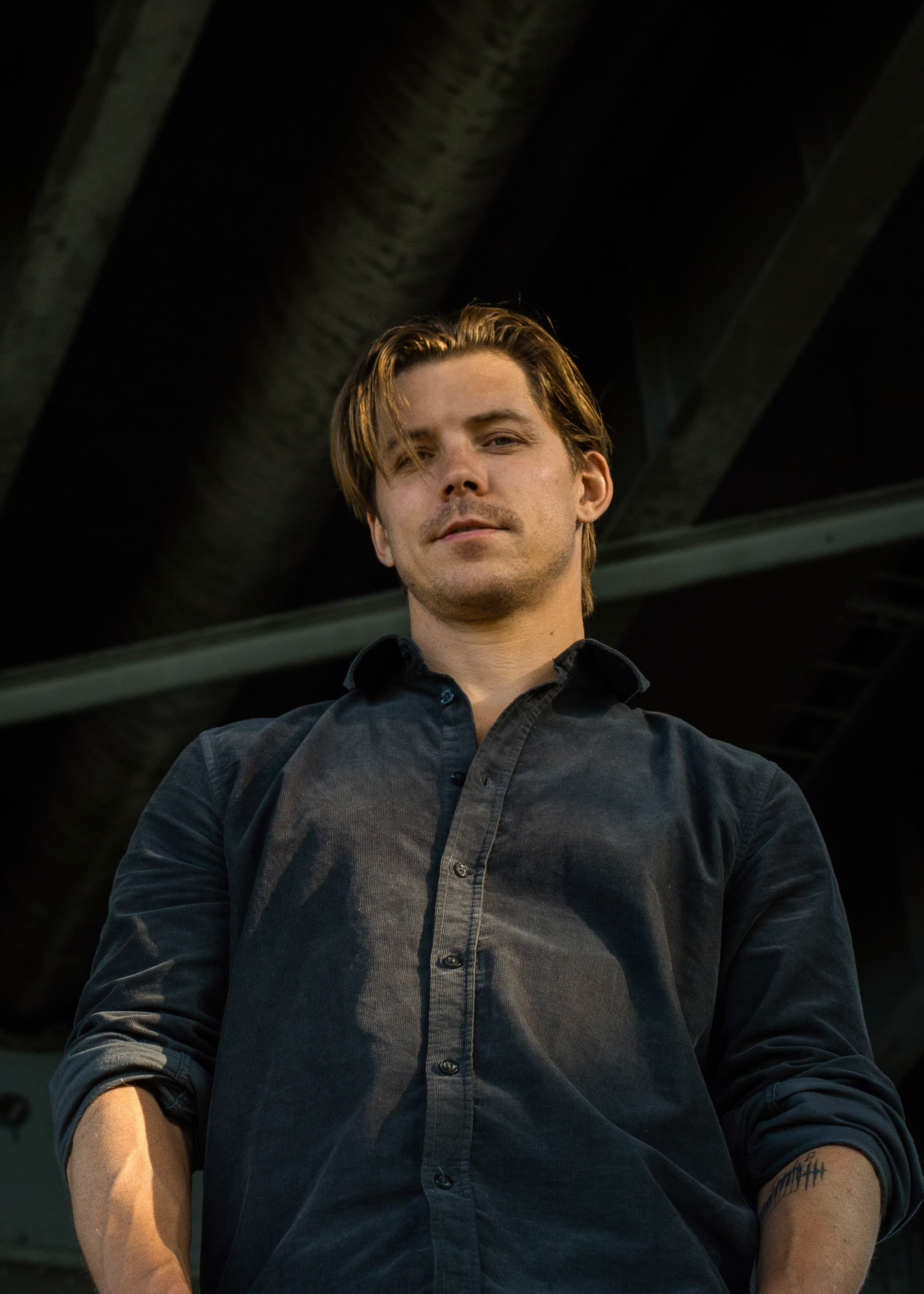 Jakko - low angle portrait in dark button-up shirt